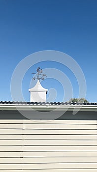 Arrow Weathervane, against the clean blue sky. Vertical photo image.