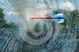 arrow in a window with broken glass
