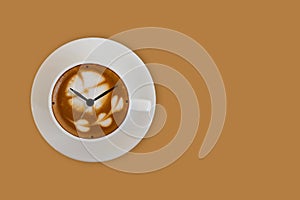 Arrows of clock on the a cup of coffee surface