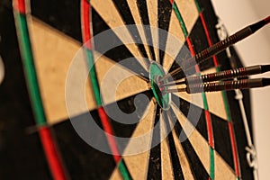 Arrows hitting dartboard - close-up photo