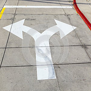 Arrows and lines on the asphalt to indicate the direction of driving