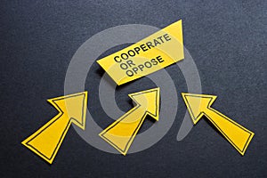 Arrows with phrase cooperate or oppose. Teamwork choice.