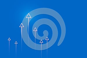 Arrows up on blue background, copy space composition, business growth concept.