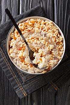 Arroz Con Coco Colombian Coconut Rice close up in the bowl. Vertical top view photo