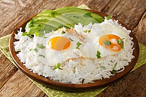 Arroz con huevo is a popular lazy lunch throughout Latin America, consisting of rice thatÃ¢â¬â¢s topped with a fried egg close up in photo