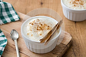 Arroz con leche. Rice pudding with cinnamon on wood