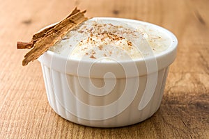 Arroz con leche. Rice pudding with cinnamon on wood