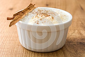 Arroz con leche. Rice pudding with cinnamon on wood photo