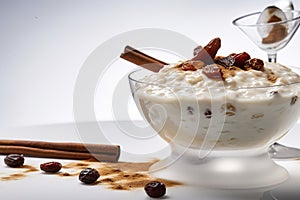 Arroz con Leche - rice pudding topped with raisins and cinnamon. AI generative image. photo