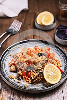 Arroz con verduras y azafran, spanish dish. Vegetarian risotto with  vegetables, champignons and saffron photo