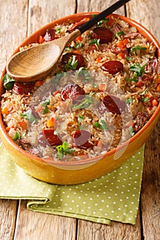 Arroz de pato or duck rice is a traditional Portuguese food close up in the baking dish. Vertical