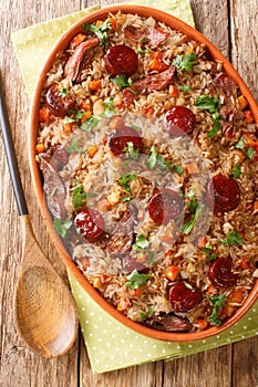 Arroz de pato or duck rice is a traditional Portuguese food close up in the baking dish. Vertical top view