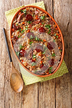 Arroz de Pato Portuguese Style Duck Rice with onion, carrot and chorizo close up in the baking dish. Vertical top view photo