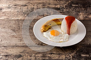 Arroz a la cubana Typical Cuban rice with fried banana and fried egg on a plate