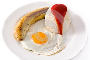 Arroz a la cubana.Typical Cuban rice with fried banana and fried egg on a plate isolated on white background.