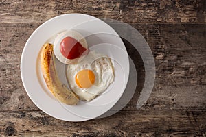 Arroz a la cubana Typical Cuban rice with fried banana and fried egg on a plate on wood