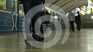 Arrrival of subway train. People in metropolitan platform waiting for train.