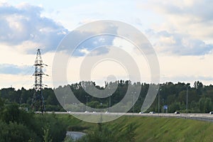 Ð¡ars move on modern highway near power transmission line