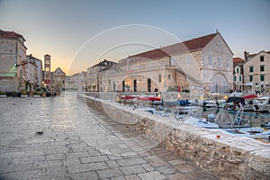 Arsenal in Hvar with cathedral of Saint Stephan in background, Croatia