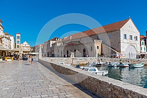 Arsenal in Hvar with cathedral of Saint Stephan in background, Croatia