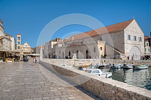 Arsenal in Hvar with cathedral of Saint Stephan in background, Croatia