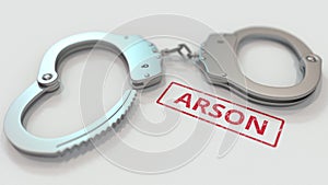 ARSON stamp and handcuffs. Crime and punishment related conceptual 3D rendering