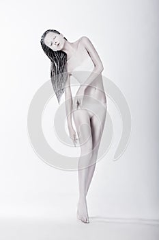 Art Bodypainting. Silhouette of Enigmatic Stylized Female Painted White