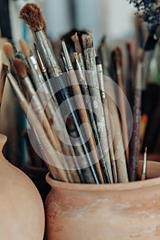 Art brushes for painting in a ceramic pot