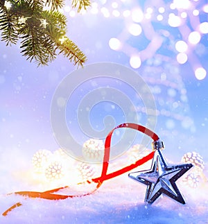 Art Christmas Holiday Background with Christmas Tree decoration on light blue snow background;  greeting banner flat lay backdrop