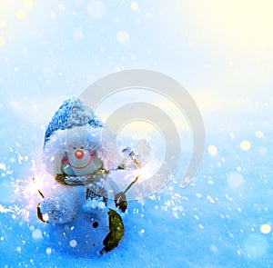 Art Christmas snowman and sparklers on blue snow background