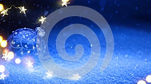 Art Christmas tree light and holidays decoration on blue snow