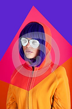 Art collage with alternative funky girl with blue hair on bright blue purple pink background. Close up fashion portrait