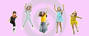 Art collage made of portraits of little and happy kids isolated on purple-pink studio background. Human emotions, facial