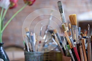 Art and craft tools close up view . Colorful array of paintbrushes and paints