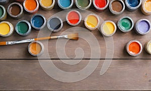 Art creative table background with watercolor paints palette paintbrushes tools on wooden desk