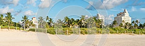 Art deco district of South Beach Miami. The buildings are surrounded by tropical palm trees.