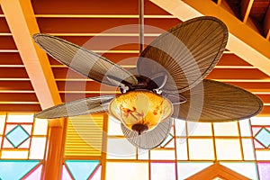 An Art Deco Fan Against Brightly Lit Lead-Light Windows