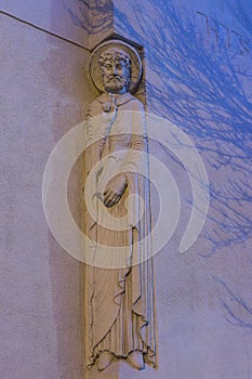 Art deco statue of Catholic Evangelist with right hand raised