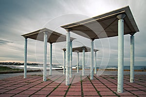 Art deco style pergolas located on a promenade next to the beach photo