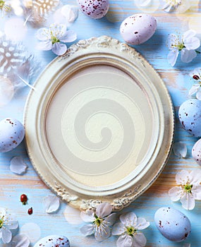 Art Easter banner with painted eggs and vintage frame on light blue backround. Top view, flat lay with copy space