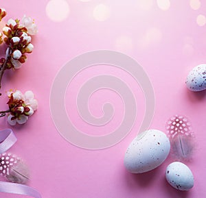 Art Easter eggs and Beautiful spring cherry tree flowers on pink background. Springtime Easter background