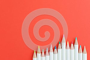 Art, education and coloring hobby concept with color pencils in row on red background with copy space