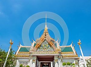 Art at facade and entrance door in The Temple of Emerald Buddha, the most beautiful landmark in Bangkok, Thailand