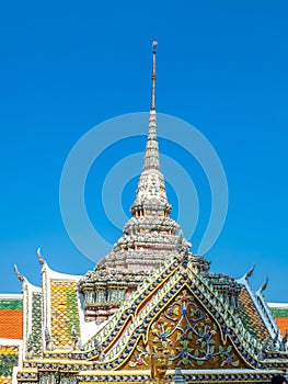 Art at facade and entrance door in The Temple of Emerald Buddha, the most beautiful landmark in Bangkok, Thailand