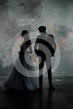 Art fashion studio photo of wedding couple silhouette groom and bride on colors background. Art Wedding style