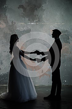Art fashion studio photo of wedding couple silhouette groom and bride on colors background. Art Wedding style