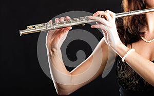 Art. Hands of flutist flaustist musician playing flute