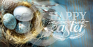 Art Happy Easter; Easter eggs in basket on the blue table backgrou