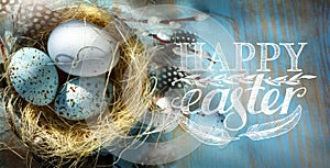 Art Happy Easter; Easter eggs in basket on the blue table backgrou photo