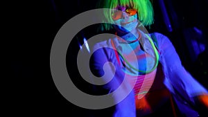 Art image of a woman in neon light bright fluorescent makeup, colored skin, body art design disco women